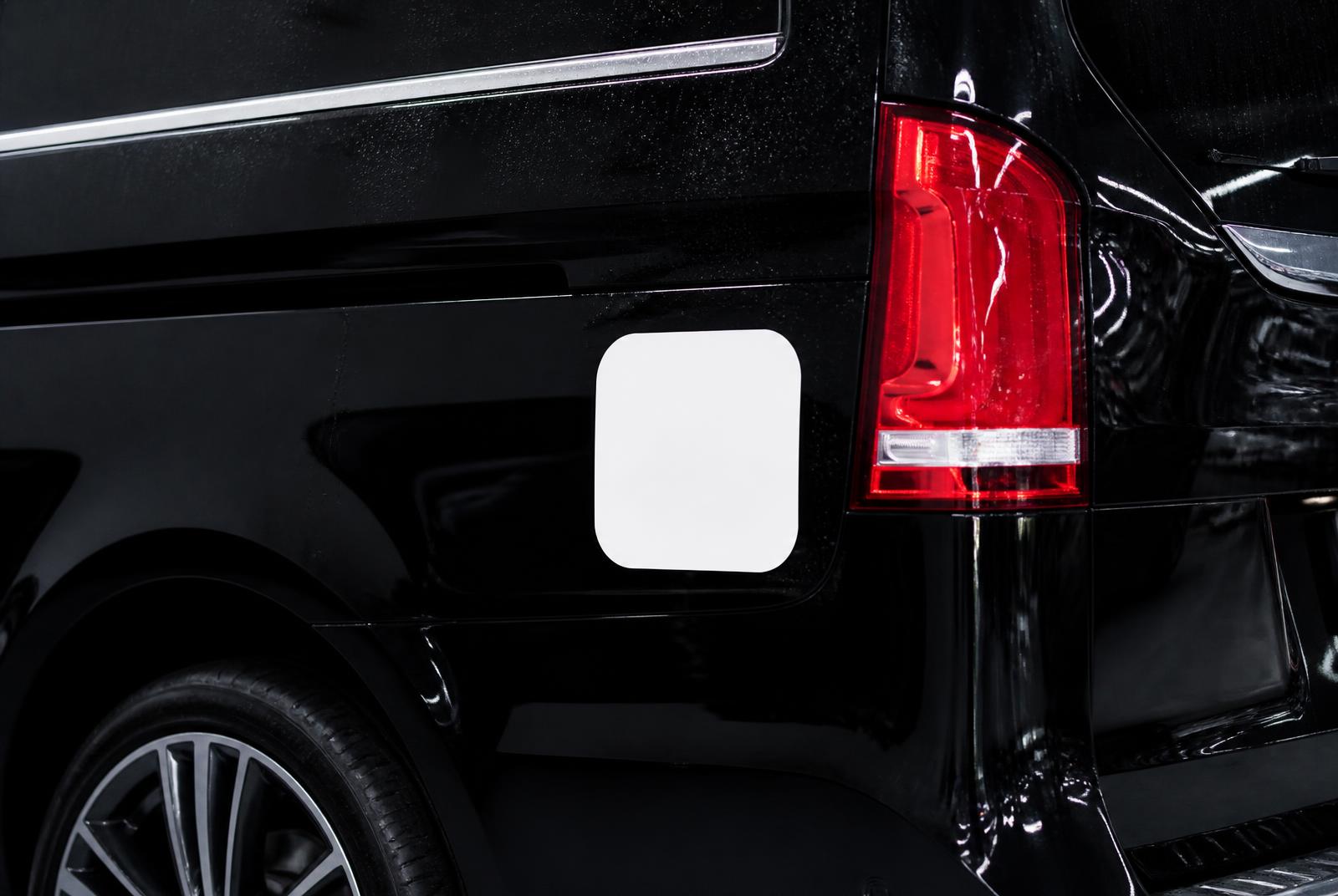 A white vinyl decal applied to a black luxury van