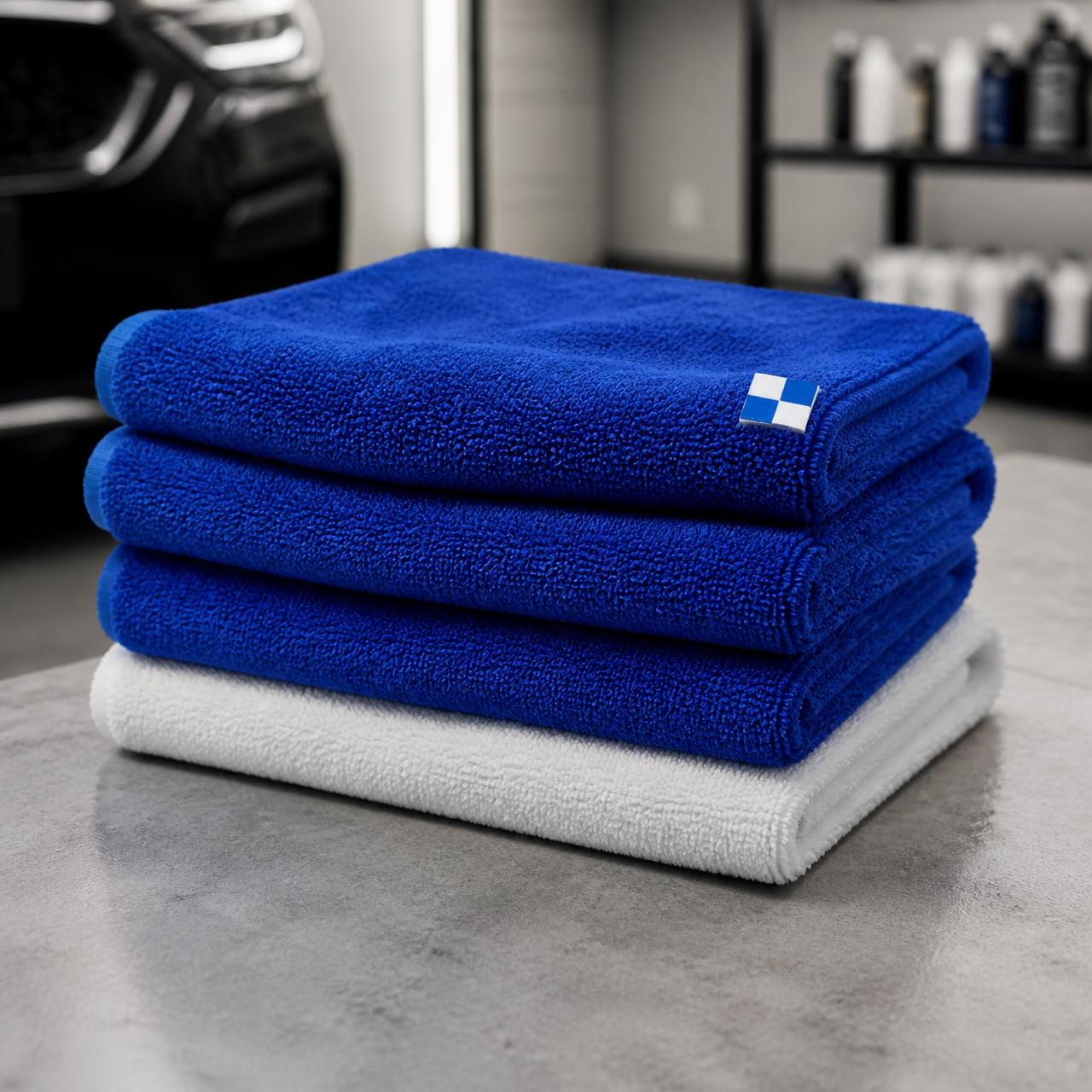 A stack of blue and white microfiber detailing towels